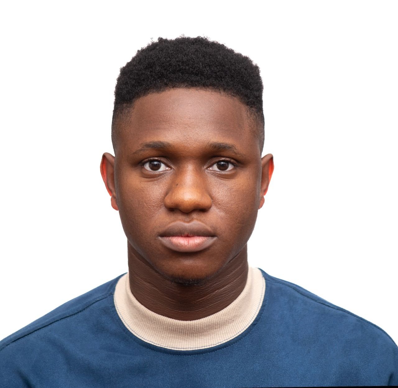 Close-up portrait of a serious young man with neutral expression on white background.